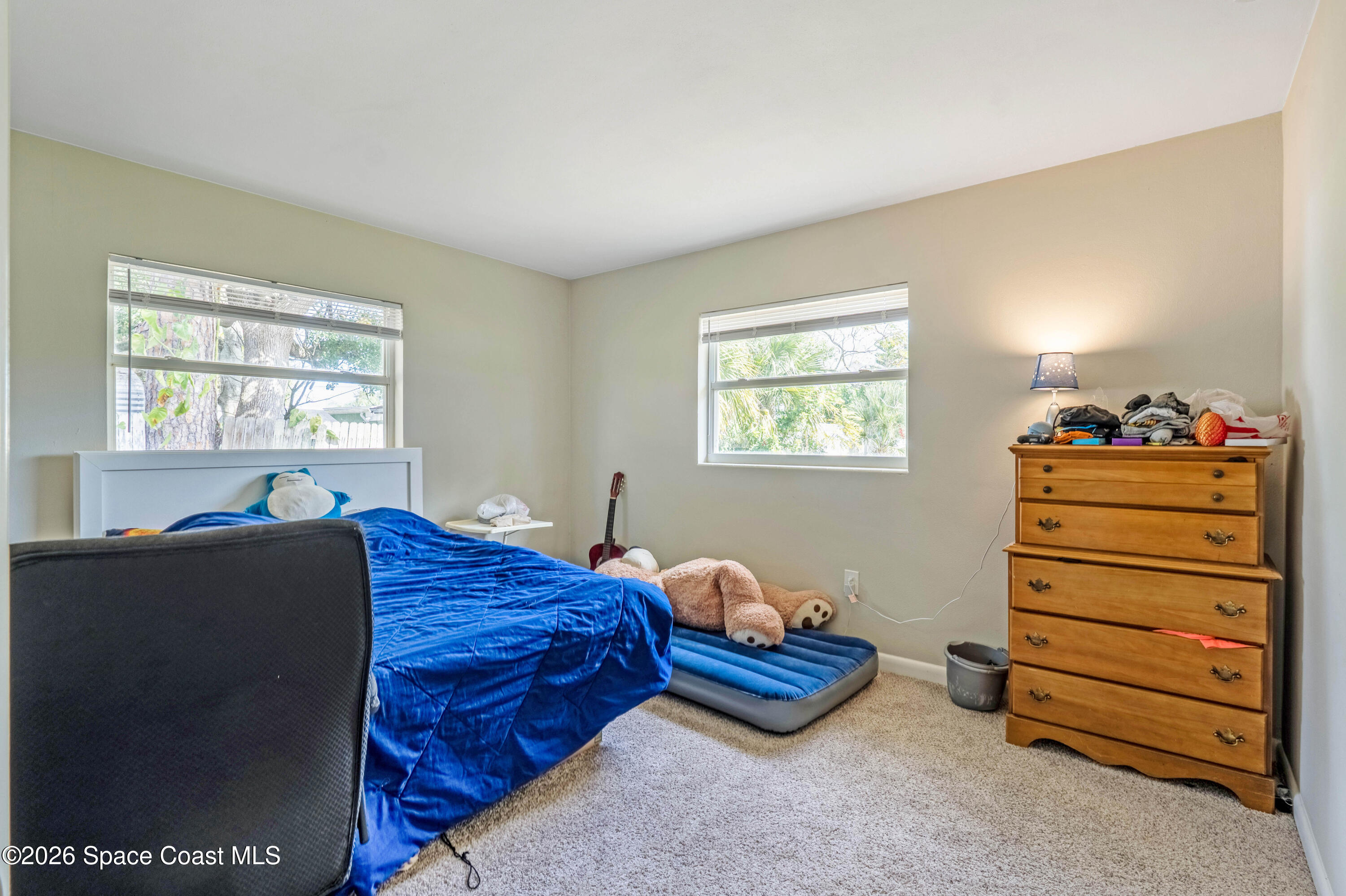 220 Alhambra Street Titusville, FL 32780 - Photo 11 of 29 a bedroom with two beds and a window