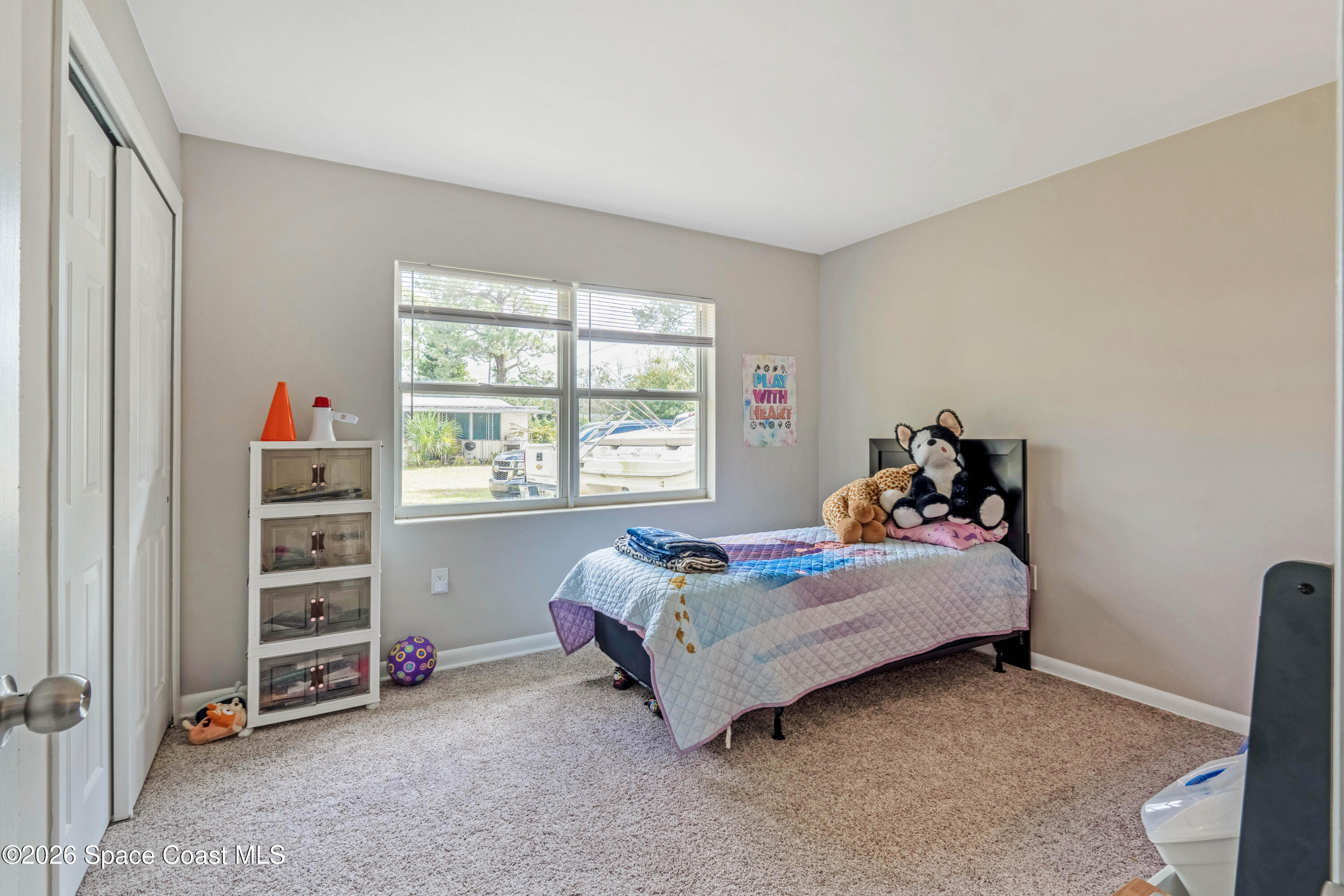 220 Alhambra Street Titusville, FL 32780 - Photo 13 of 29 a bedroom with a bed and a window