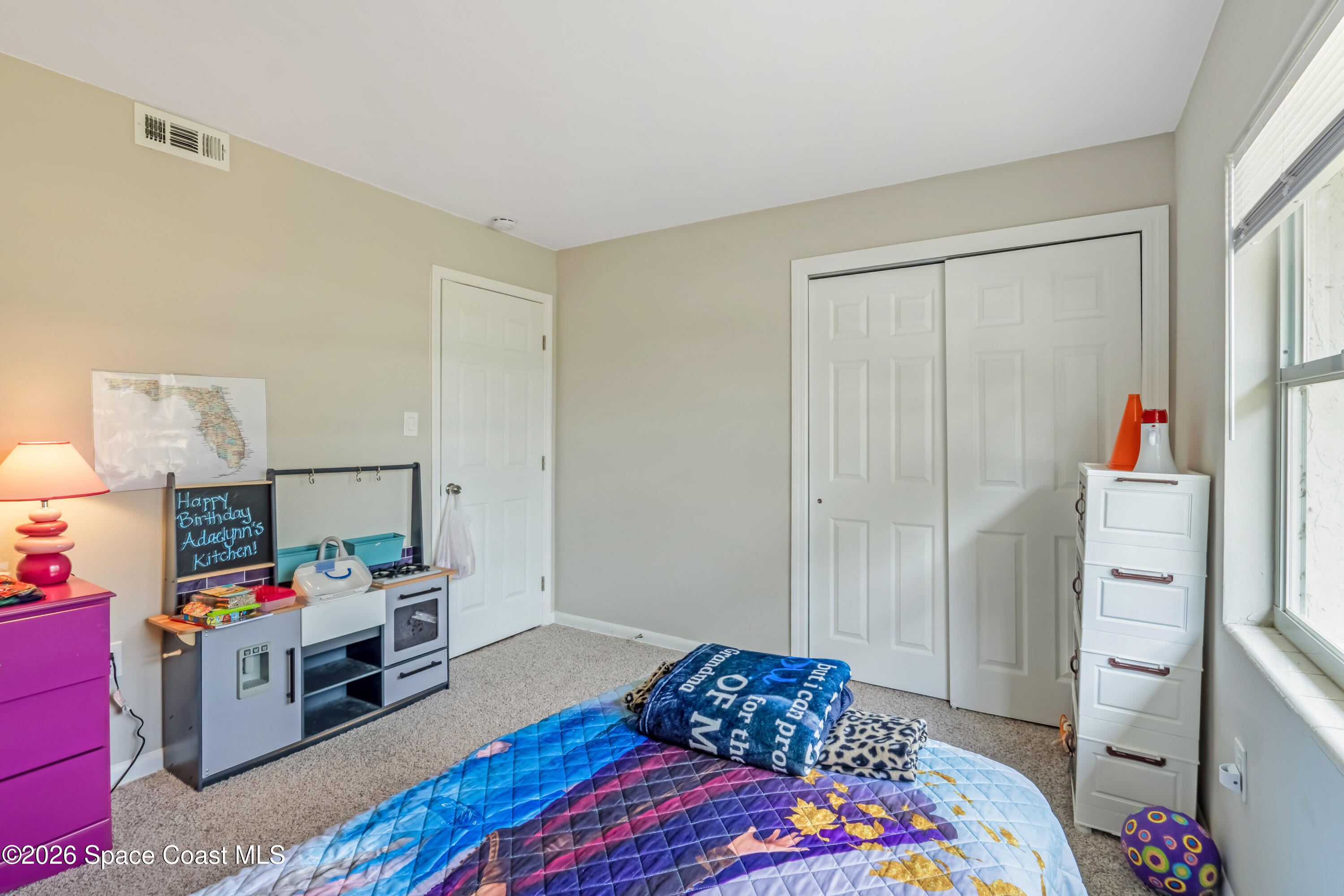 220 Alhambra Street Titusville, FL 32780 - Photo 14 of 29 a bedroom with a bed and a window