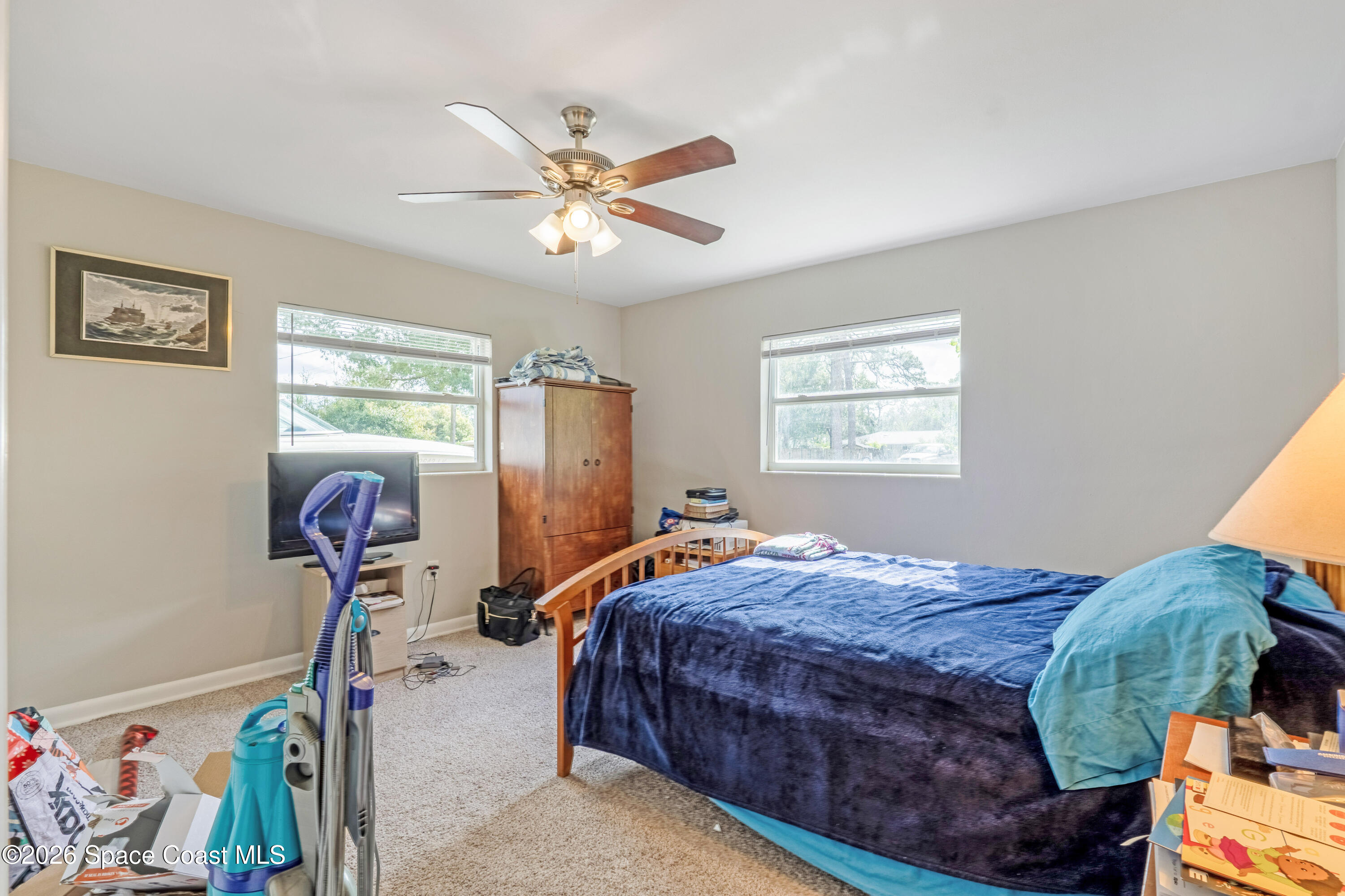 220 Alhambra Street Titusville, FL 32780 - Photo 15 of 29 a bedroom with bed and a window