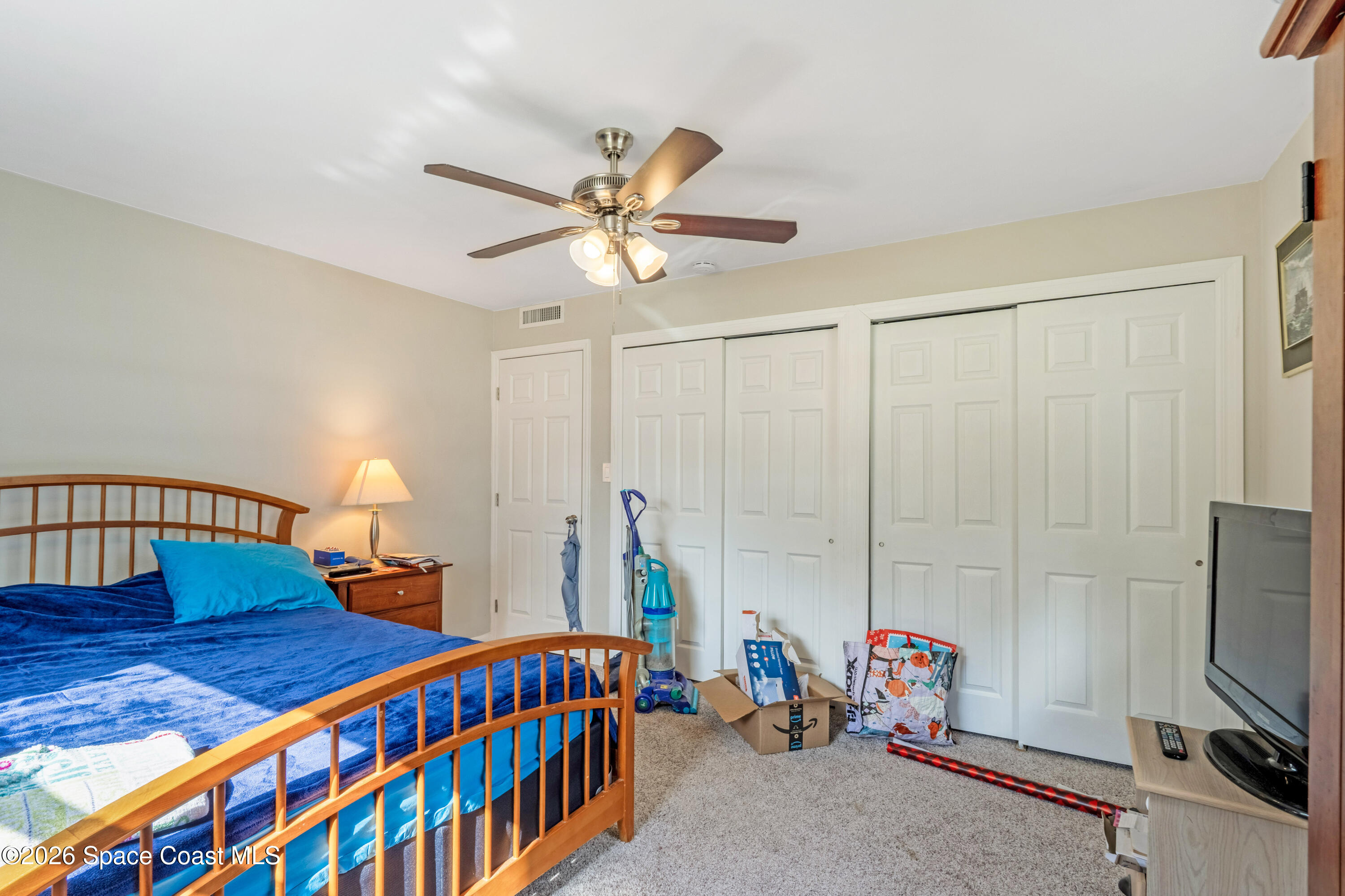 220 Alhambra Street Titusville, FL 32780 - Photo 16 of 29 a bedroom with furniture and a chandelier