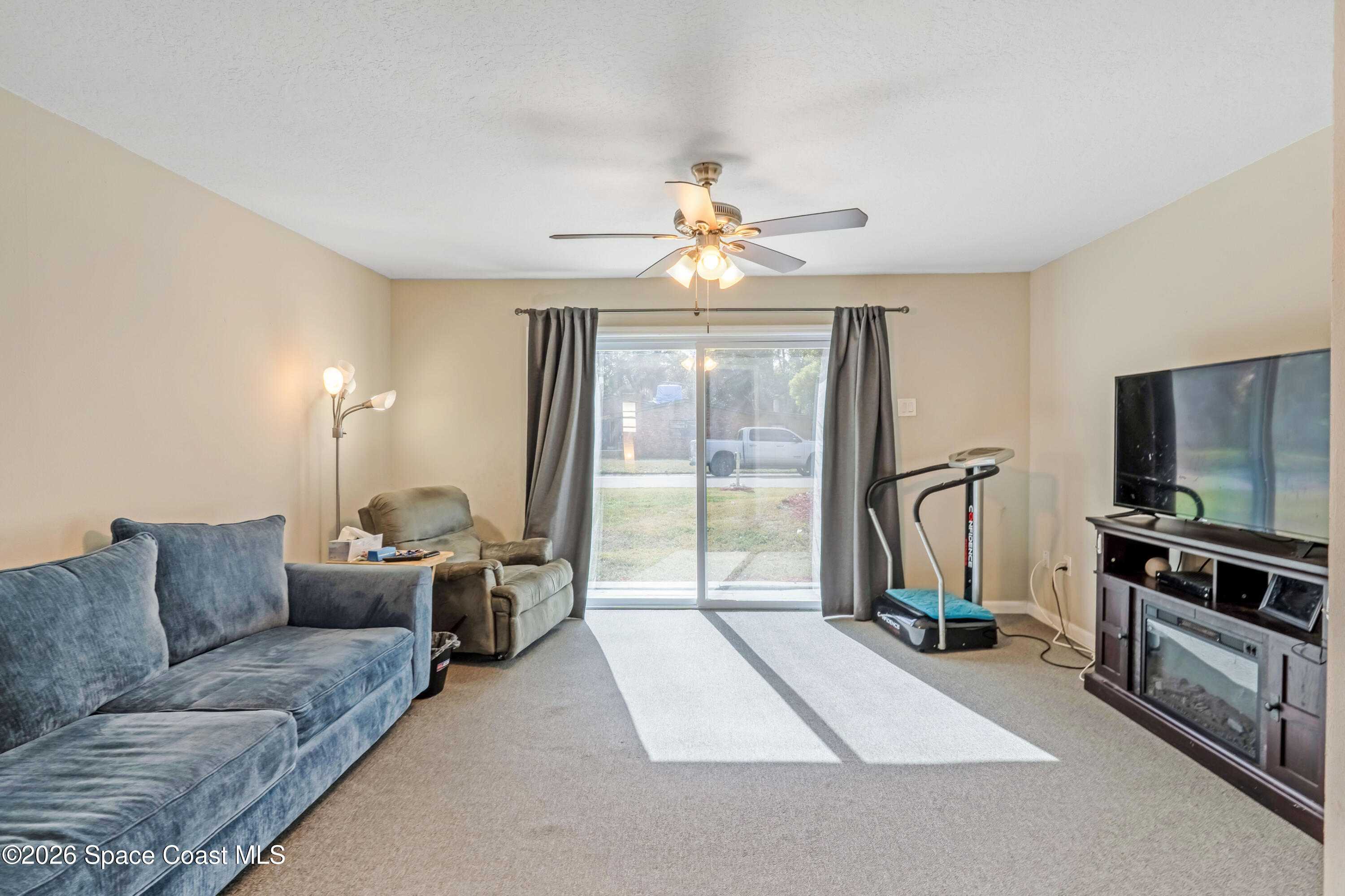 220 Alhambra Street Titusville, FL 32780 - Photo 18 of 29 a living room with furniture and a flat screen tv
