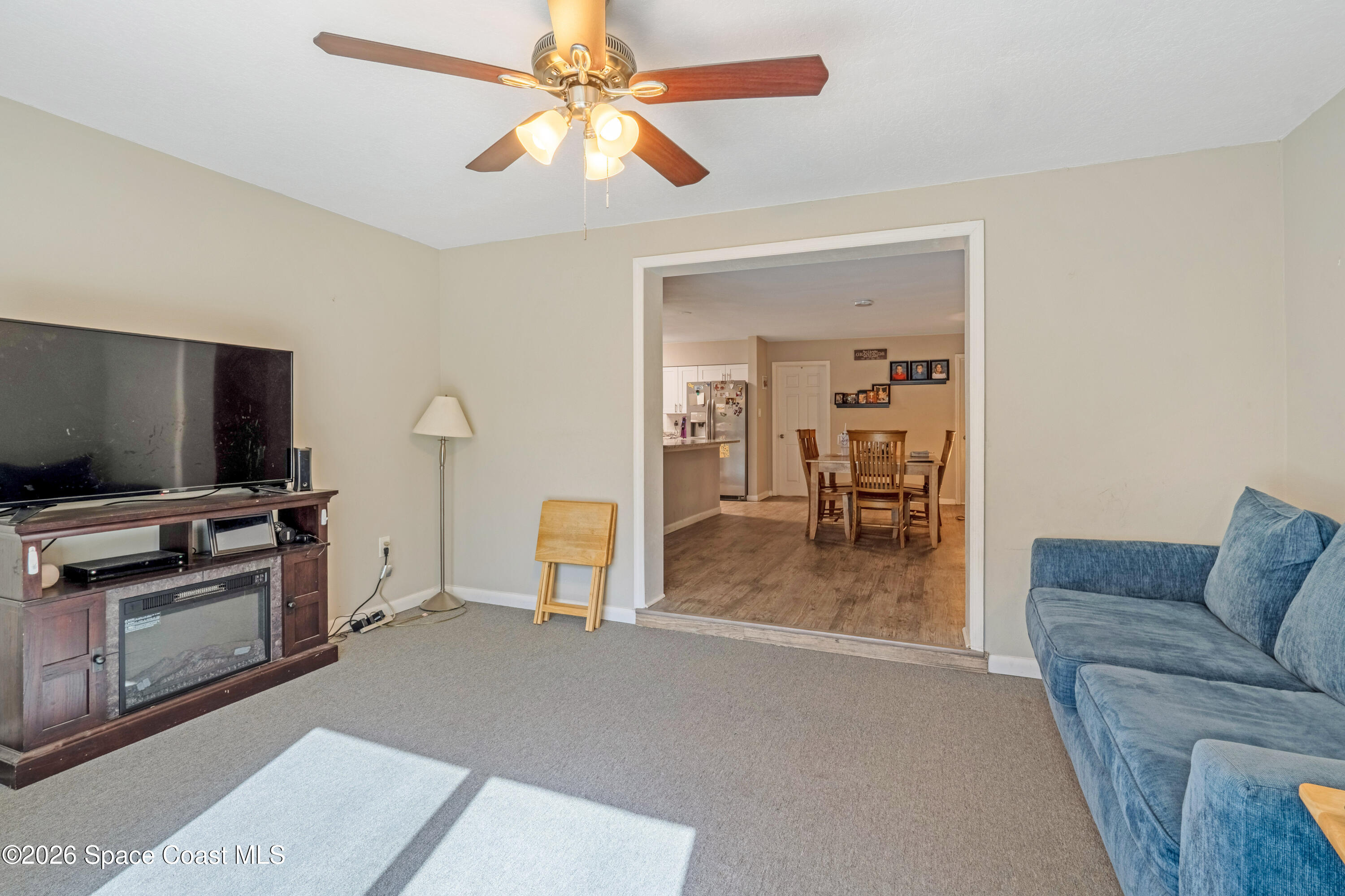 220 Alhambra Street Titusville, FL 32780 - Photo 19 of 29 a living room with furniture and a flat screen tv