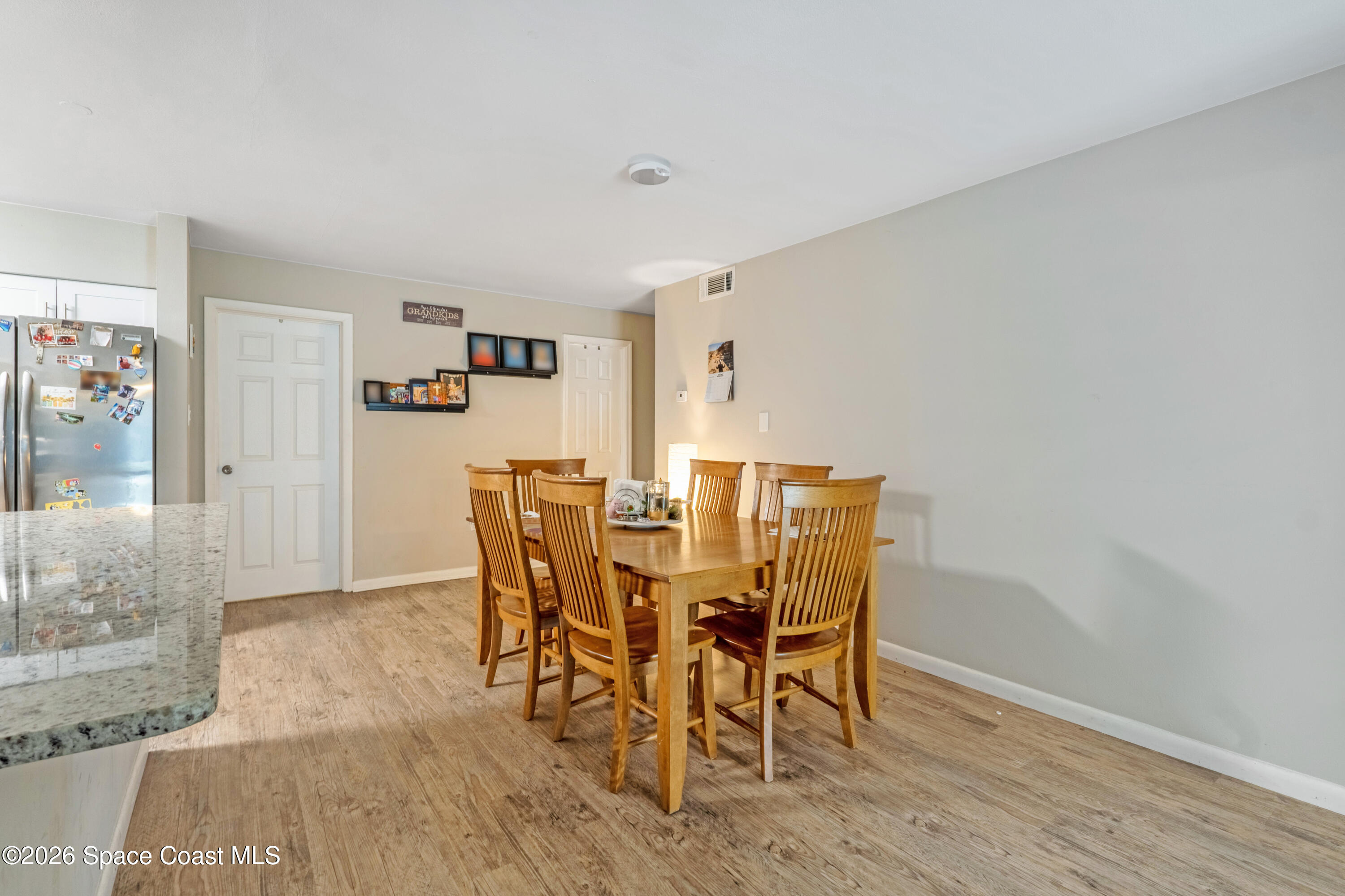 220 Alhambra Street Titusville, FL 32780 - Photo 20 of 29 a view of a dining room with furniture and wooden floor