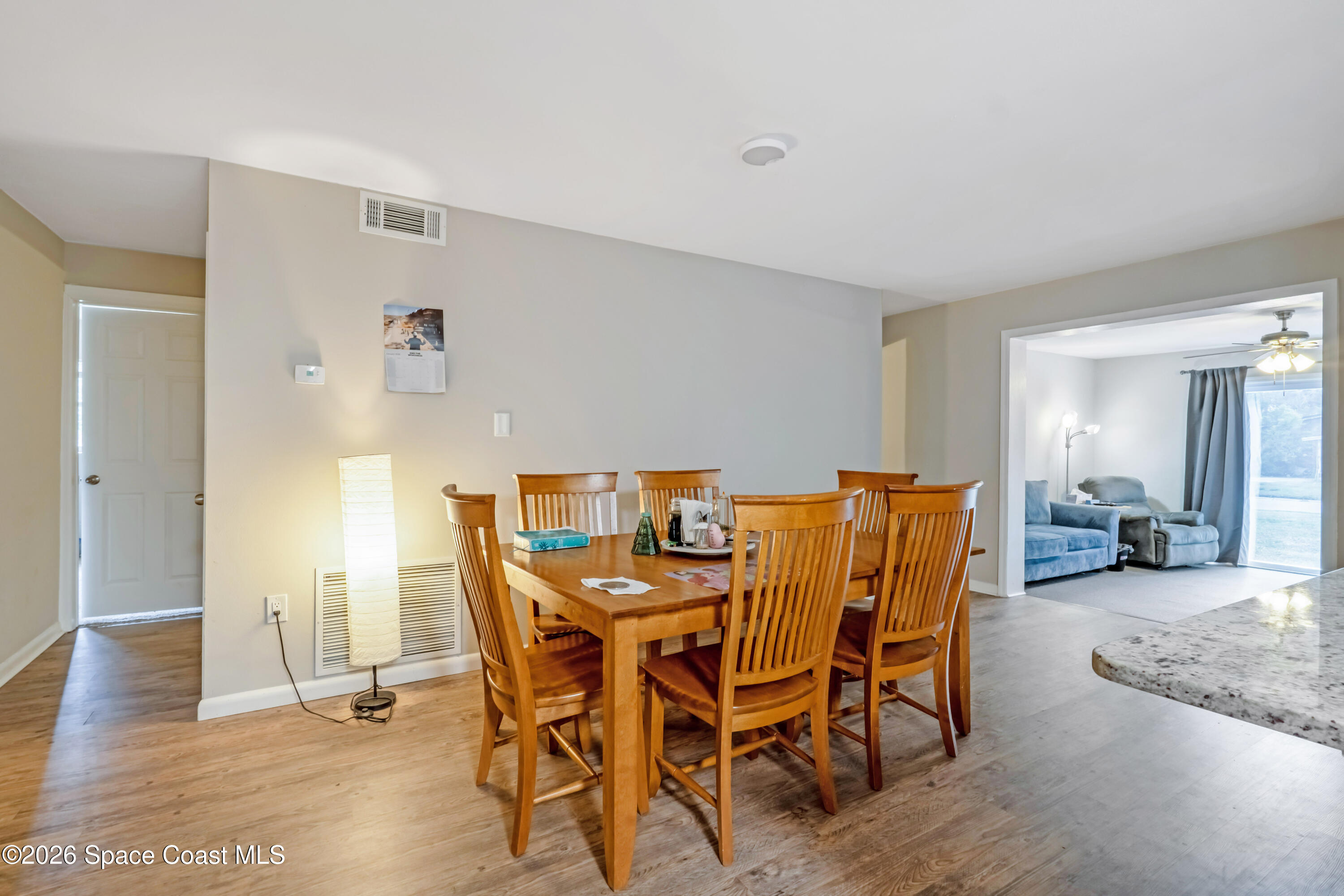 220 Alhambra Street Titusville, FL 32780 - Photo 21 of 29 a view of a dining room with furniture and wooden floor