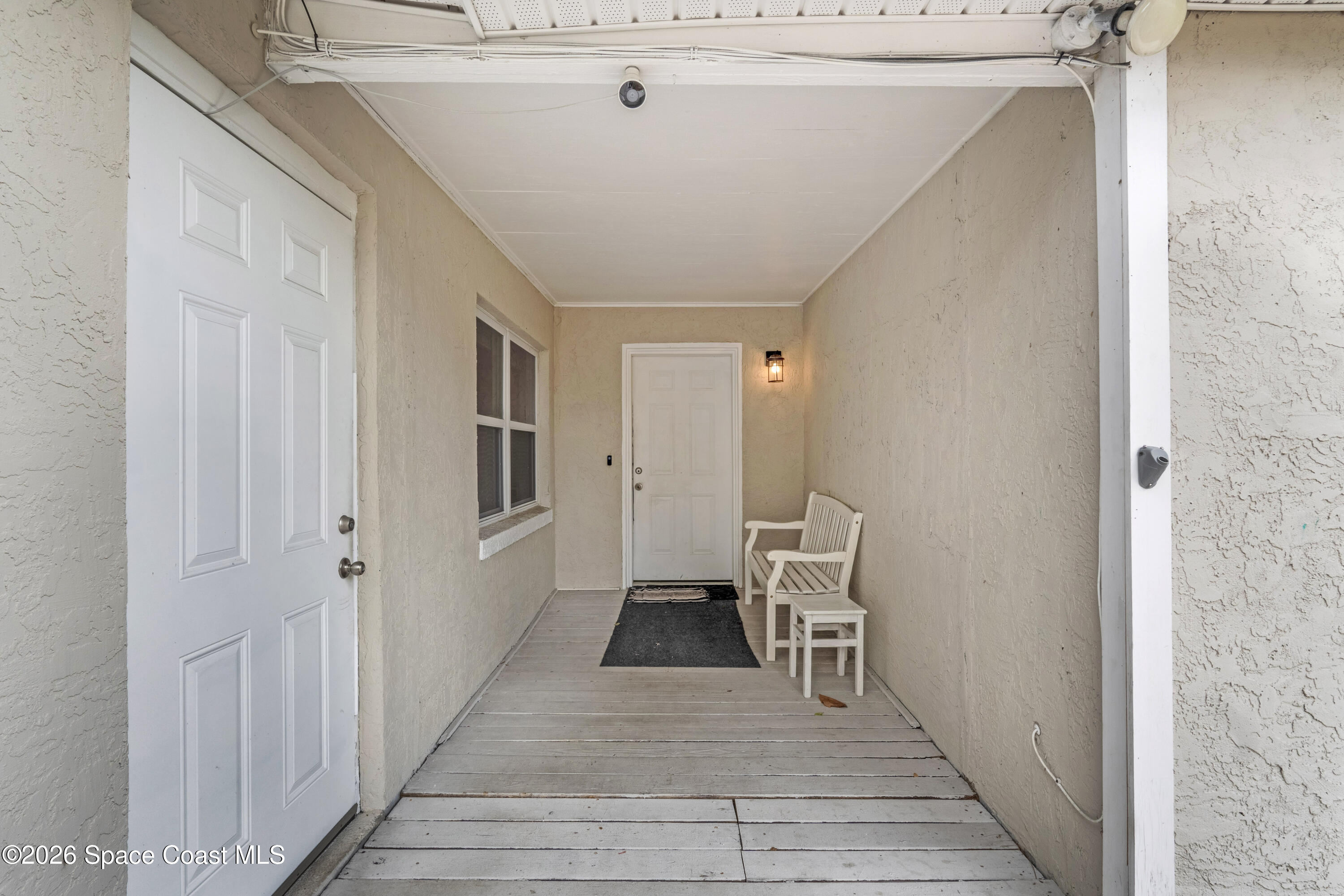 220 Alhambra Street Titusville, FL 32780 - Photo 7 of 29 a view of a hallway with wooden floor and staircase