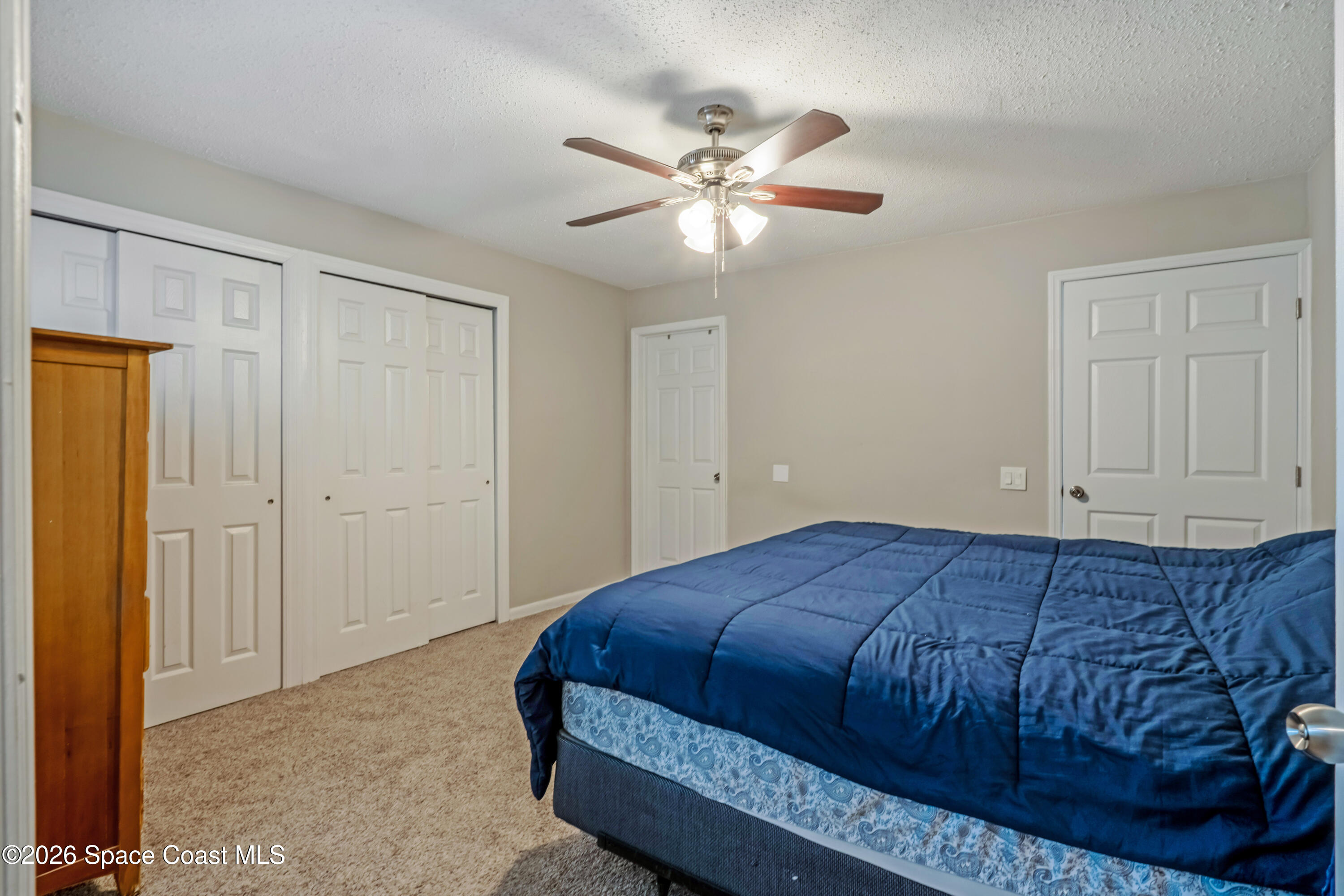 220 Alhambra Street Titusville, FL 32780 - Photo 8 of 29 a bedroom with a bed and cabinet