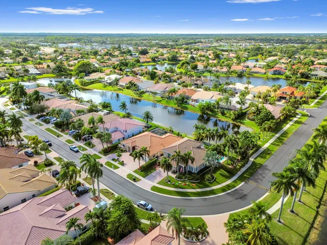 a front view of a house with a yard and lake view