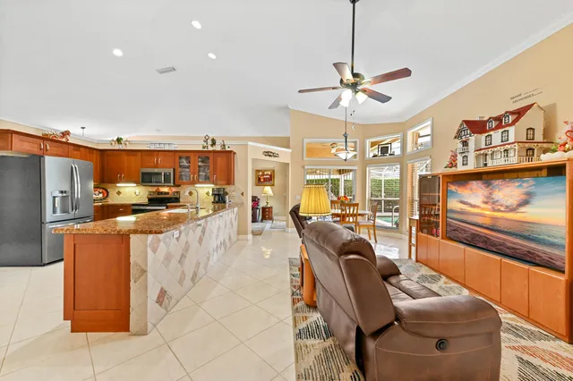 a bedroom with a bed and a large window with the outer view