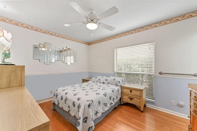 a bedroom with a bed and a flat tv screen on the dresser
