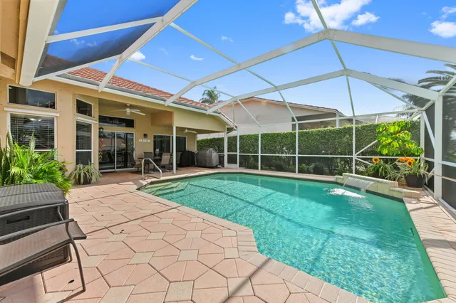 a front view of a house with a yard and potted plants