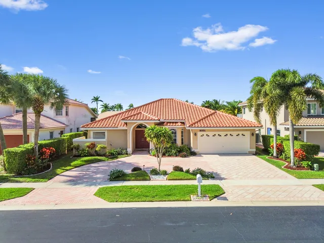 a view of a hallway to a livingroom with wooden floor and a rug
