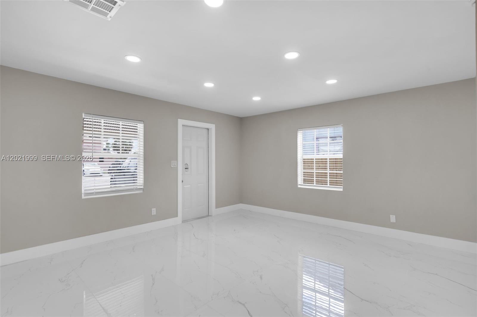 1660 West 26th Street Riviera Beach, FL 33404 - Photo 7 of 28 a view of an empty room with a window