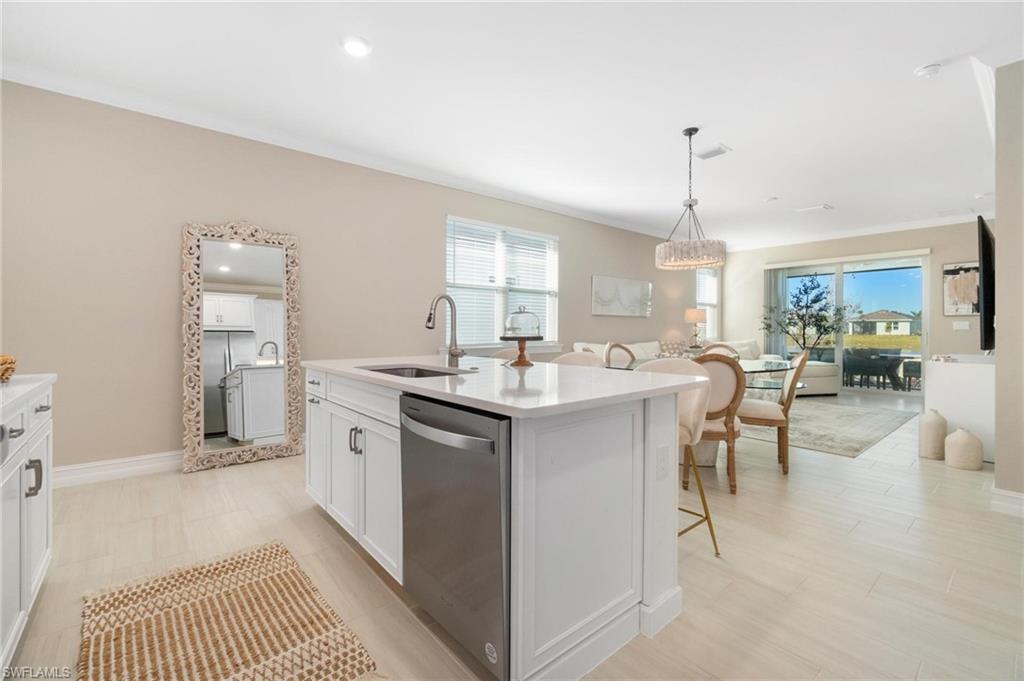 28298 Captiva Shell Loop Bonita Springs, FL 34135 - Photo 20 of 49 a kitchen with cabinets and chairs