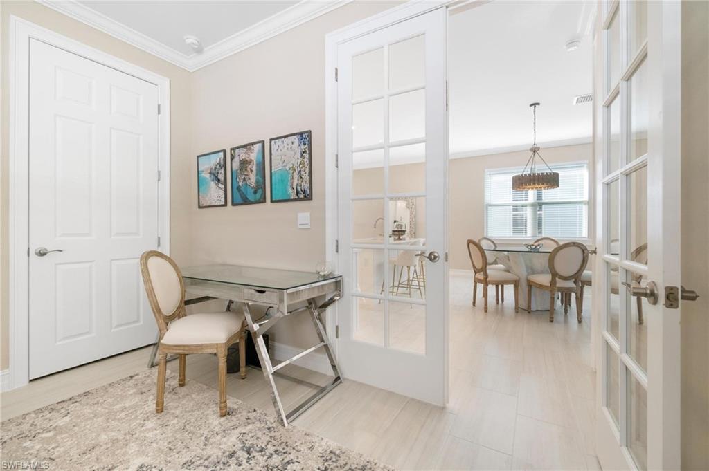 28298 Captiva Shell Loop Bonita Springs, FL 34135 - Photo 25 of 49 a dining room with furniture and a floor to ceiling window