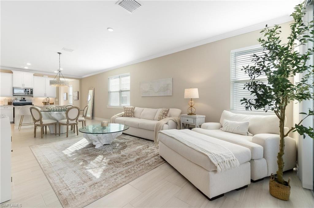 28298 Captiva Shell Loop Bonita Springs, FL 34135 - Photo 29 of 49 a large bedroom with a bed and a couch