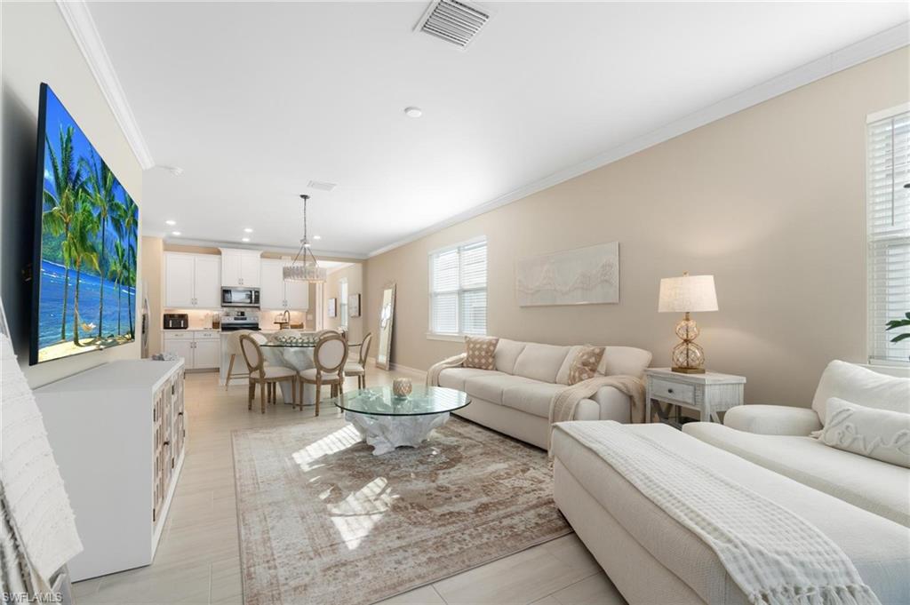28298 Captiva Shell Loop Bonita Springs, FL 34135 - Photo 30 of 49 a living room with furniture and a flat screen tv
