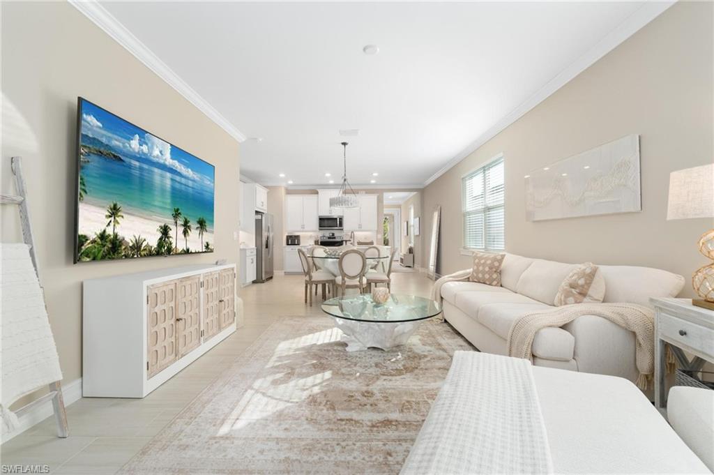 28298 Captiva Shell Loop Bonita Springs, FL 34135 - Photo 31 of 49 a living room with furniture and a flat screen tv