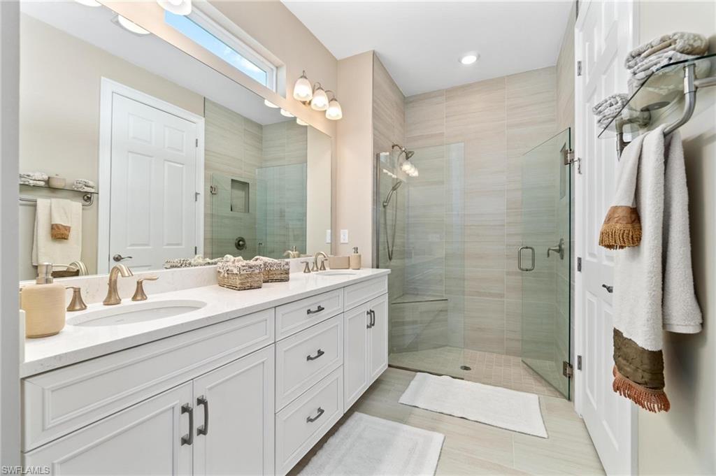 28298 Captiva Shell Loop Bonita Springs, FL 34135 - Photo 35 of 49 a bathroom with a double vanity sink mirror and shower