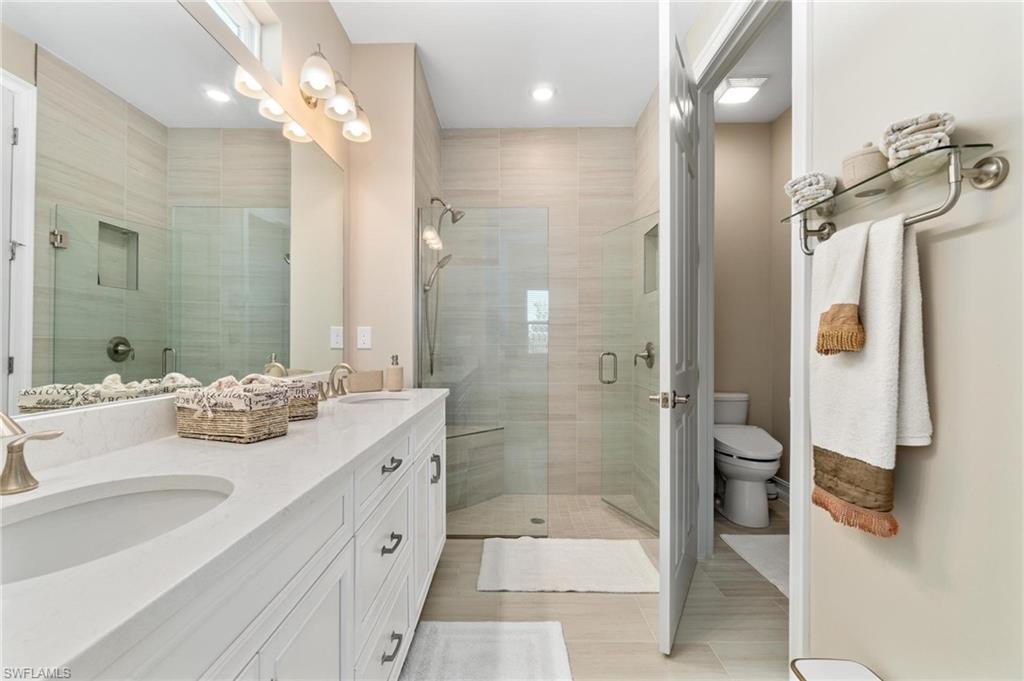 28298 Captiva Shell Loop Bonita Springs, FL 34135 - Photo 37 of 49 a bathroom with a double vanity sink mirror and shower