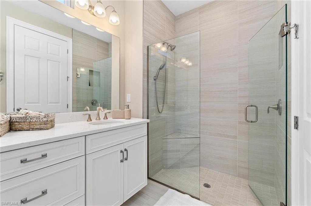 28298 Captiva Shell Loop Bonita Springs, FL 34135 - Photo 40 of 49 a bathroom with a shower sink and mirror
