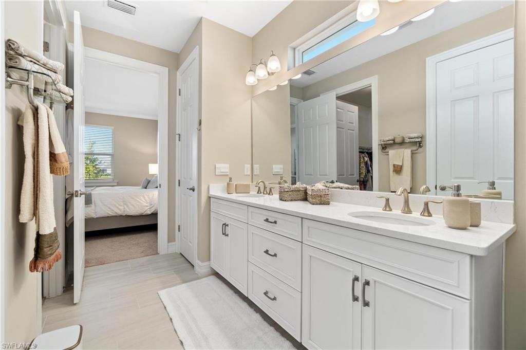 28298 Captiva Shell Loop Bonita Springs, FL 34135 - Photo 41 of 49 a en suite bathroom with double sink and a large mirror