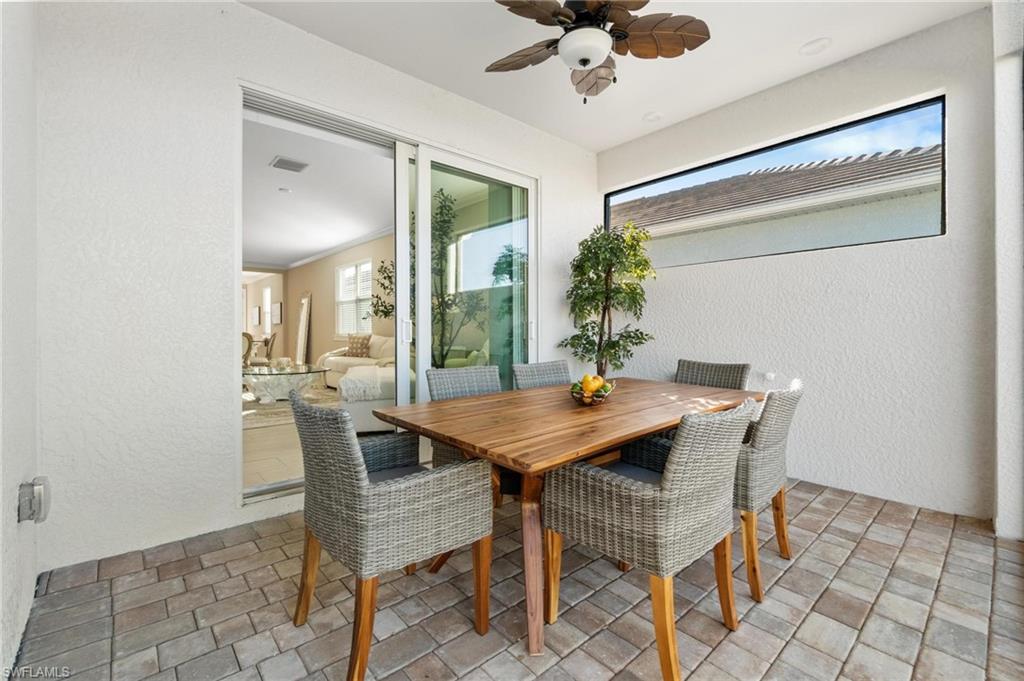 28298 Captiva Shell Loop Bonita Springs, FL 34135 - Photo 44 of 49 a view of a dining room with furniture and a chandelier fan