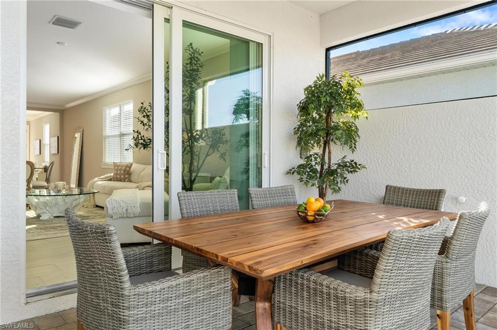 28298 Captiva Shell Loop Bonita Springs, FL 34135 - Photo 45 of 49 a view of a dining room with furniture window and wooden floor