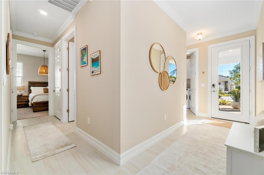 28298 Captiva Shell Loop Bonita Springs, FL 34135 - Photo 7 of 49 a view of an entryway with wooden floor and mirror