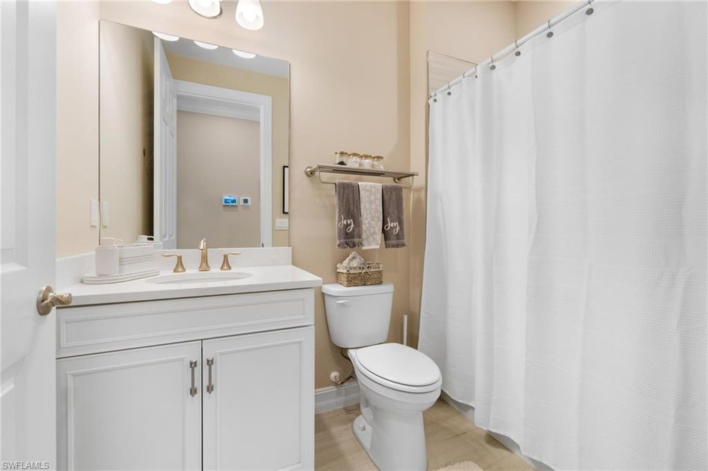 28298 Captiva Shell Loop Bonita Springs, FL 34135 - Photo 8 of 49 a bathroom with a sink a toilet and shower curtain