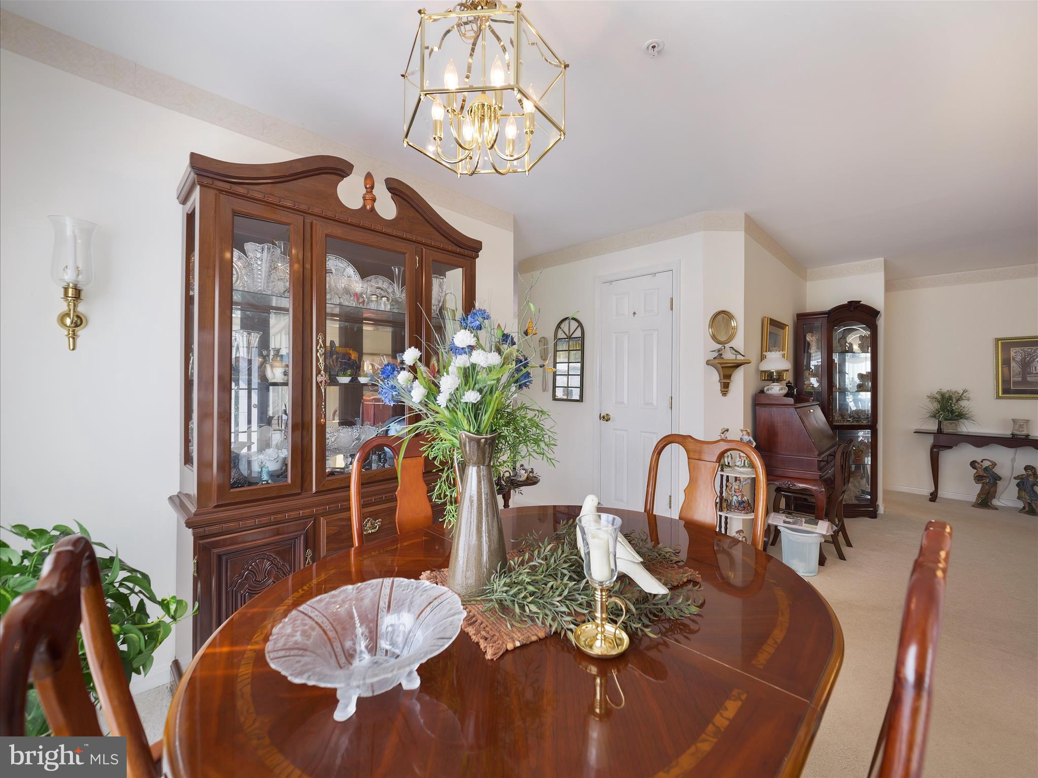 2103 Wayside Drive, Unit 1C Frederick, MD 21702 - Photo 12 of 29 a view of a dining room with furniture a chandelier and wooden floor