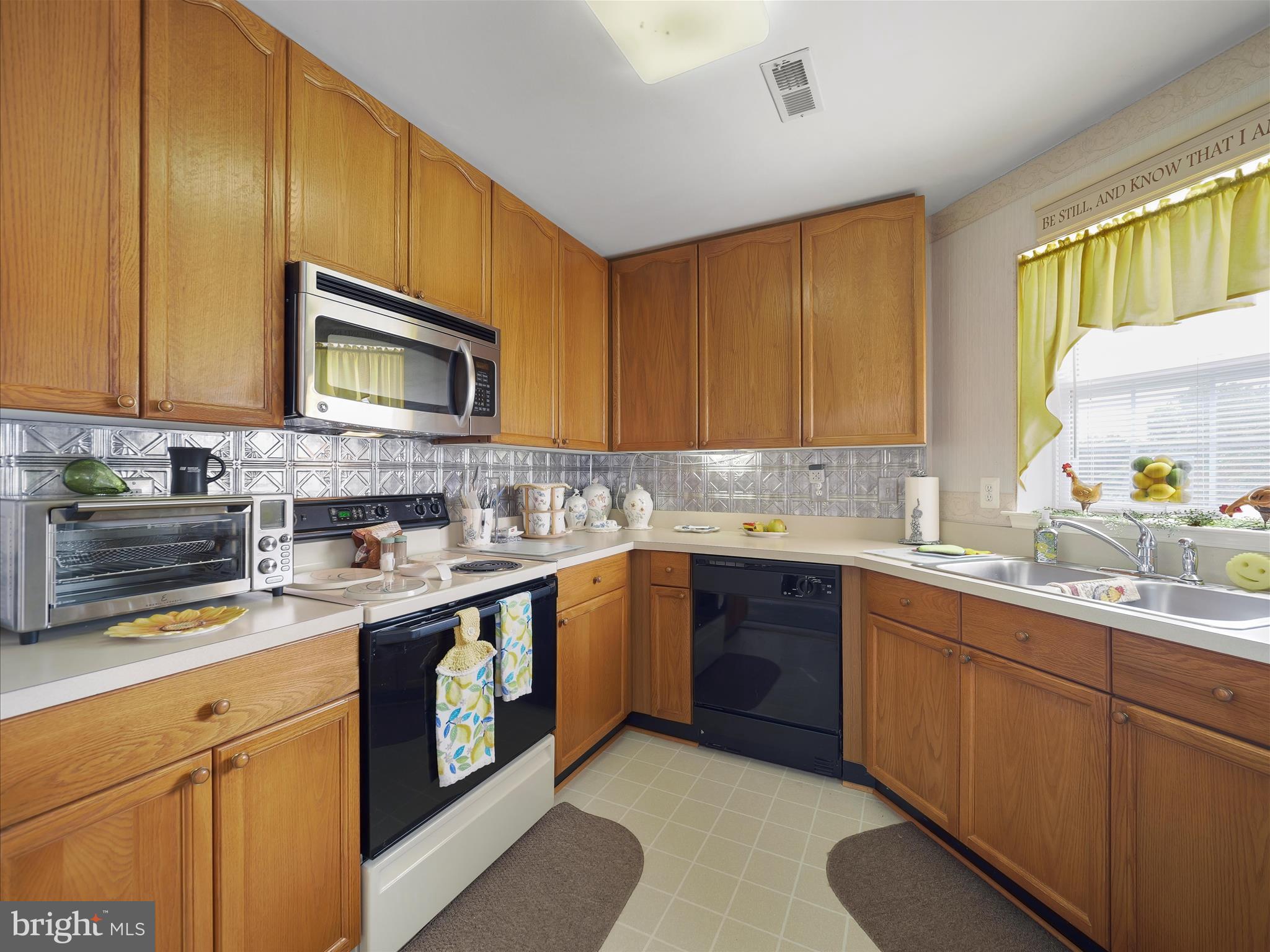 2103 Wayside Drive, Unit 1C Frederick, MD 21702 - Photo 15 of 29 a kitchen with stainless steel appliances granite countertop wooden cabinets sink and stove top oven