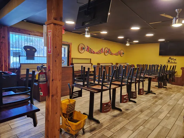 a kitchen with stainless steel appliances kitchen island granite countertop a table chairs and a large window