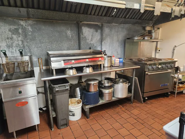 a kitchen with sink a stove and cabinets