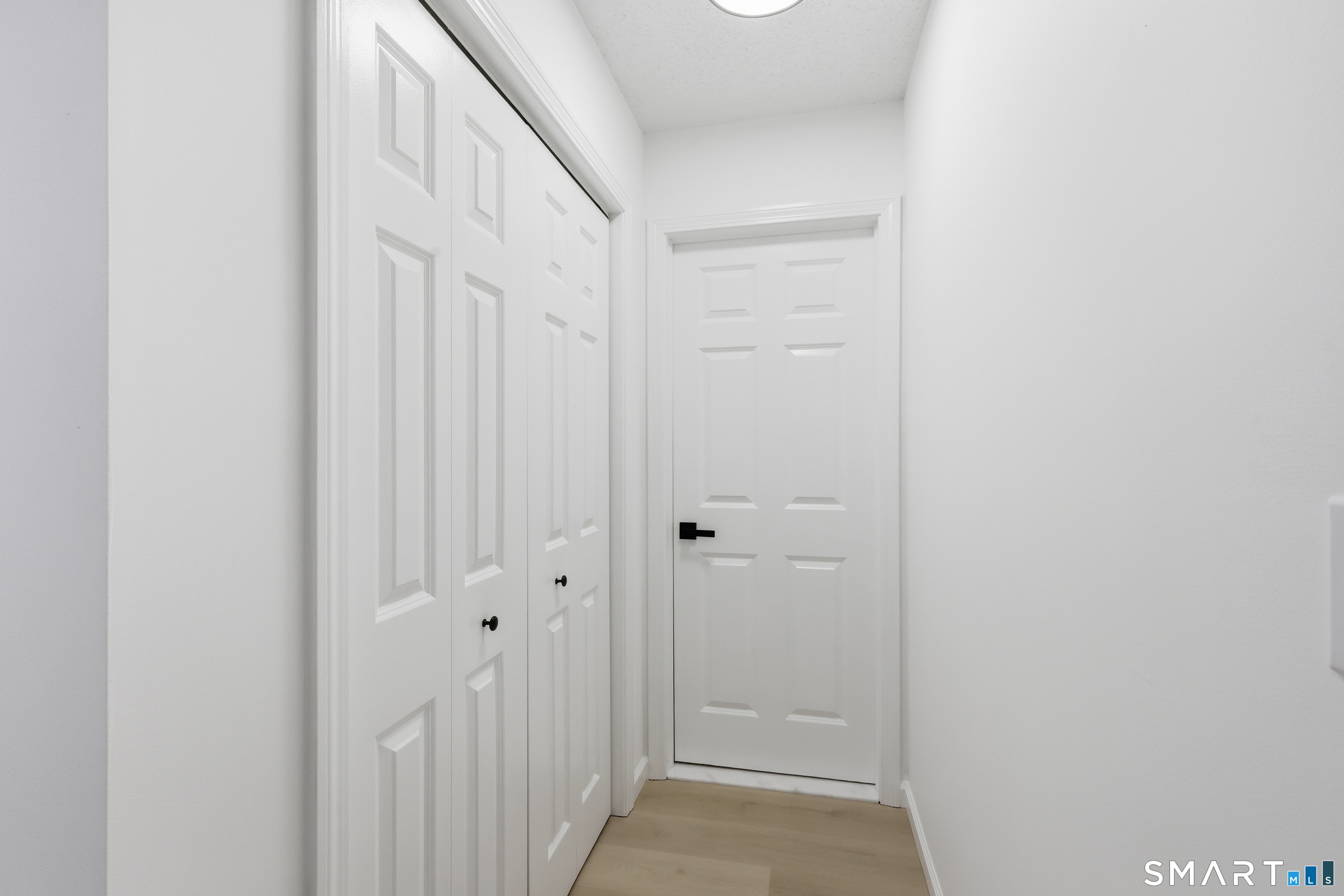 70 Victoria Court Hamden, CT 06514 - Photo 11 of 30 a view of a hallway with wooden floor