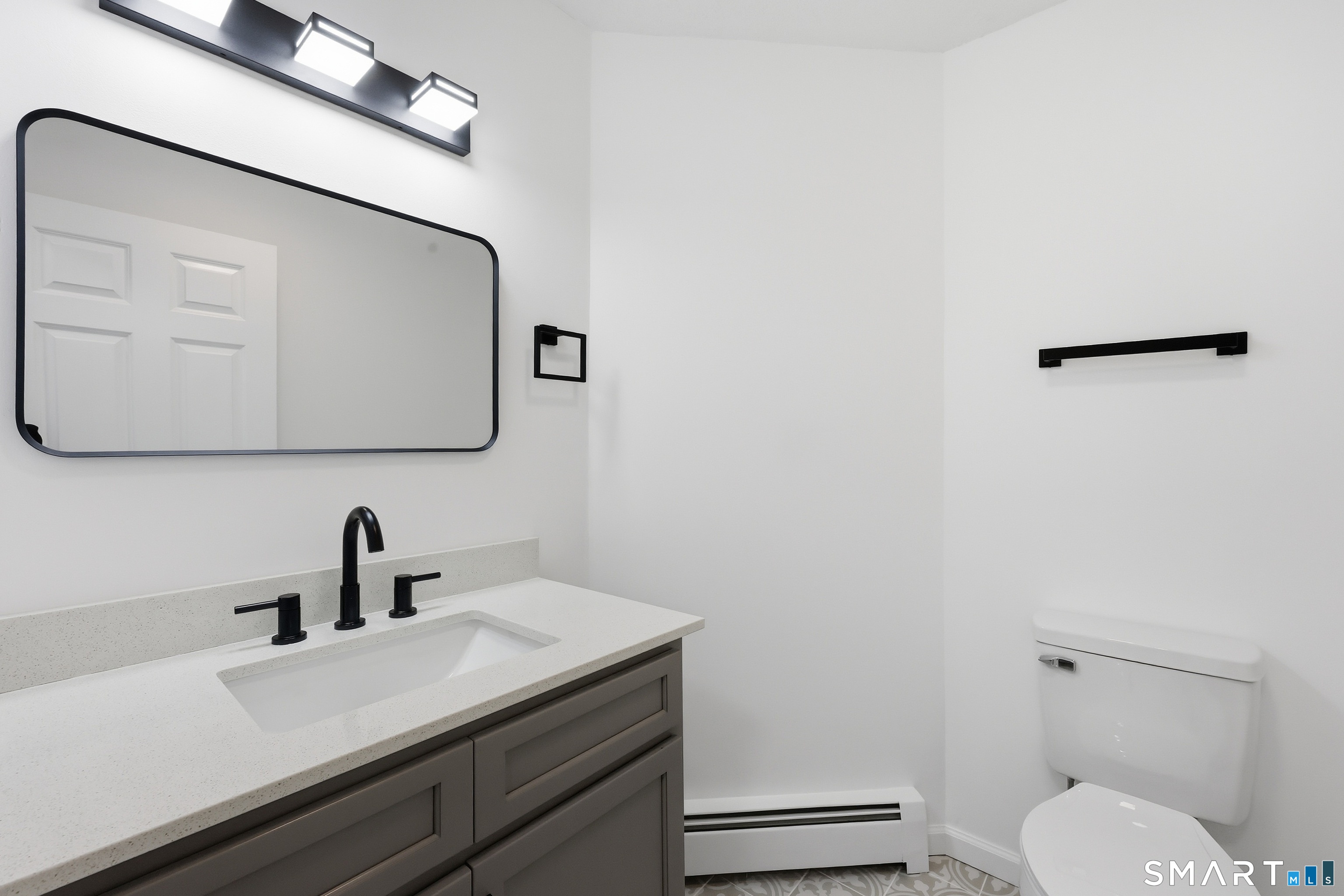 70 Victoria Court Hamden, CT 06514 - Photo 14 of 30 a bathroom with a toilet a sink and mirror