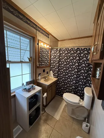 a bathroom with a granite countertop toilet a sink and a shower