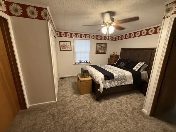 a spacious bedroom with a bed and a chandelier
