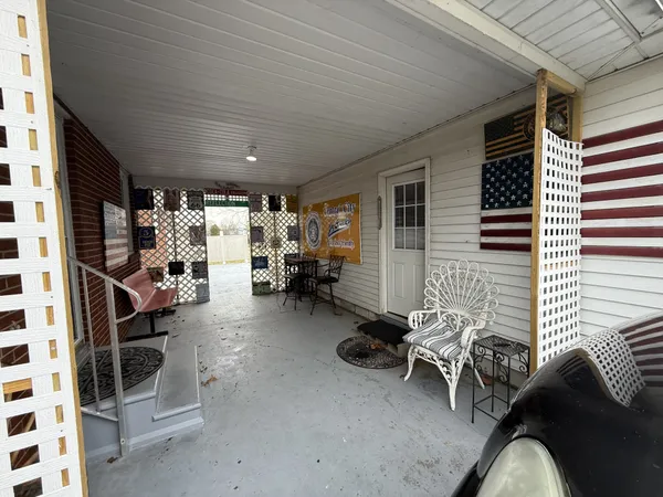 a view of living room with patio furniture and a window