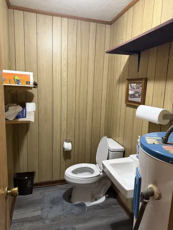 a bathroom with a toilet and a shower curtain