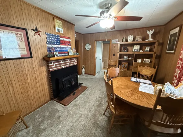 a living room with furniture a bookshelf and a fireplace
