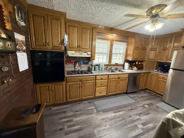 a kitchen with a sink cabinets and window