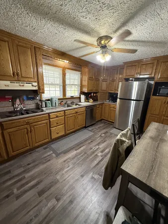 a kitchen with sink refrigerator and window