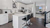 1083 Atterberg Road, Unit 4004 South Elgin, IL 60177 - Photo 5 of 18 a kitchen with stainless steel appliances a sink a stove a refrigerator cabinets and a refrigerator