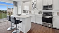 1083 Atterberg Road, Unit 4004 South Elgin, IL 60177 - Photo 7 of 18 a kitchen with stainless steel appliances a stove a sink and a microwave