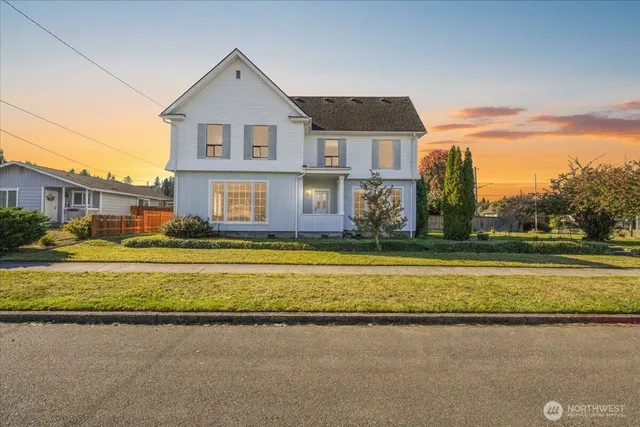 a front view of a house with a yard and swimming pool