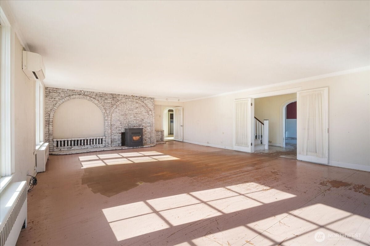 1212 3rd Street Cosmopolis, WA 98537 - Photo 5 of 31 a view of empty room with wooden floor and fireplace