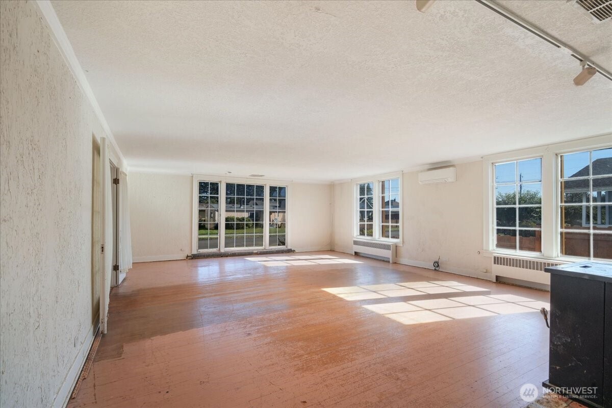 1212 3rd Street Cosmopolis, WA 98537 - Photo 6 of 31 an empty room with windows and a view of bedroom