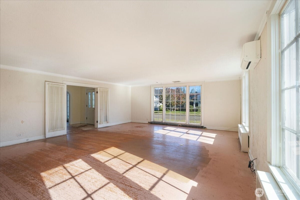 1212 3rd Street Cosmopolis, WA 98537 - Photo 7 of 31 an empty room with windows and view of wooden floor