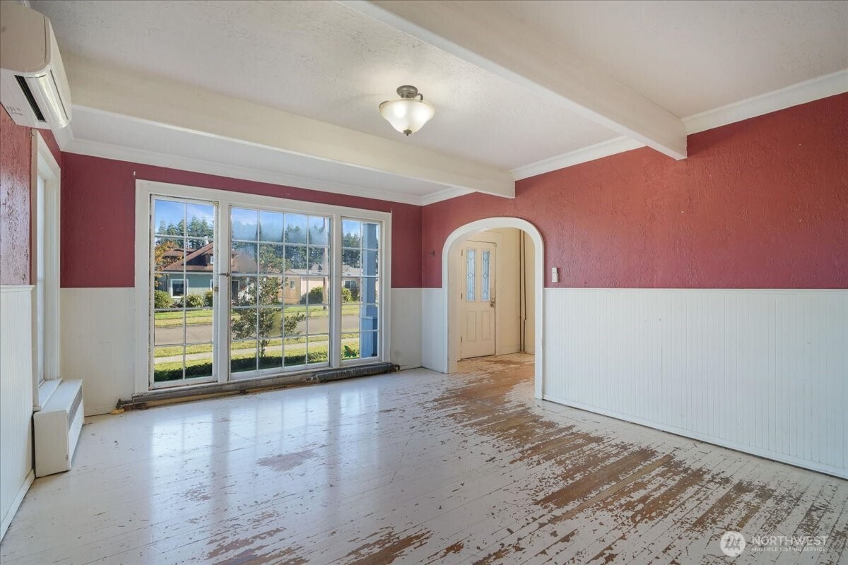 1212 3rd Street Cosmopolis, WA 98537 - Photo 8 of 31 a view of an empty room with a window and wooden floor